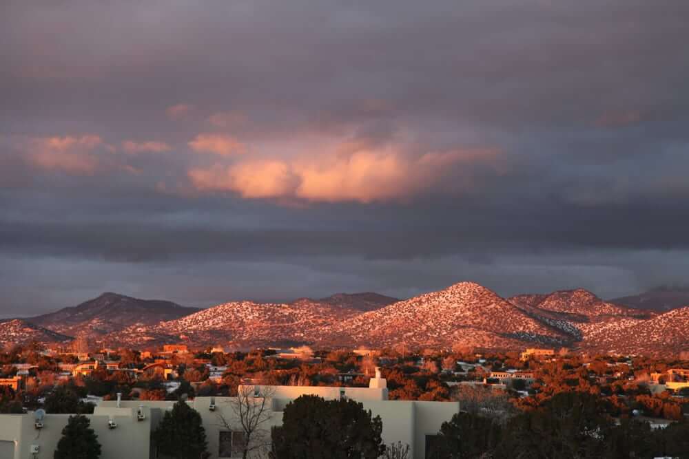Santa Fe, New Mexico at sunset is a mesmerizing sight that captivates with its unrivaled beauty and charm. The enchanting city, renowned for its architectural wonders and distinctive adobe homes