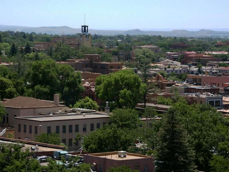 An aerial view of the city of Santa Fe, New Mexico featuring stunning architectural designs and vibrant homes.