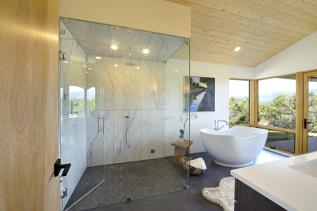 An architect or home designer may include a glass shower stall in the design of a bathroom.