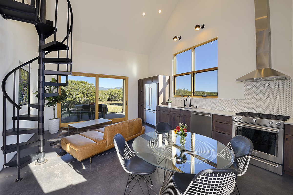 A Santa Fe inspired kitchen with a spiral staircase.