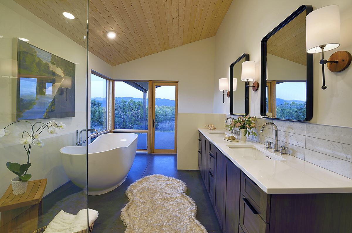 A Santa Fe style bathroom with two sinks and a tub.