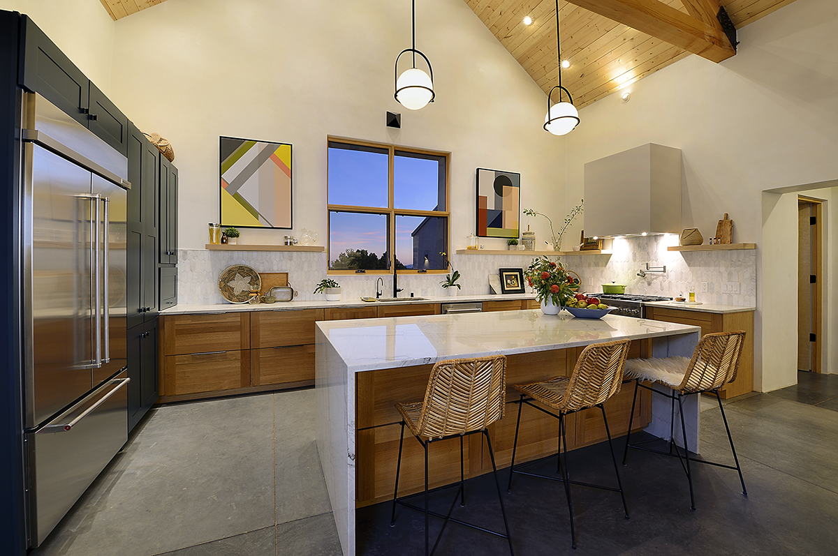 A Santa Fe kitchen with a wooden ceiling, built by a home builder contractor.