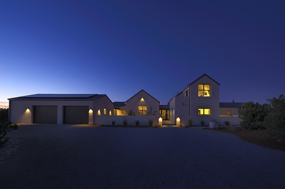 The Santa Fe house is lit up at night.