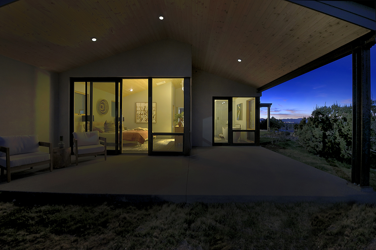 A beautiful house at night, designed by a skilled home designer and constructed by an experienced contractor.