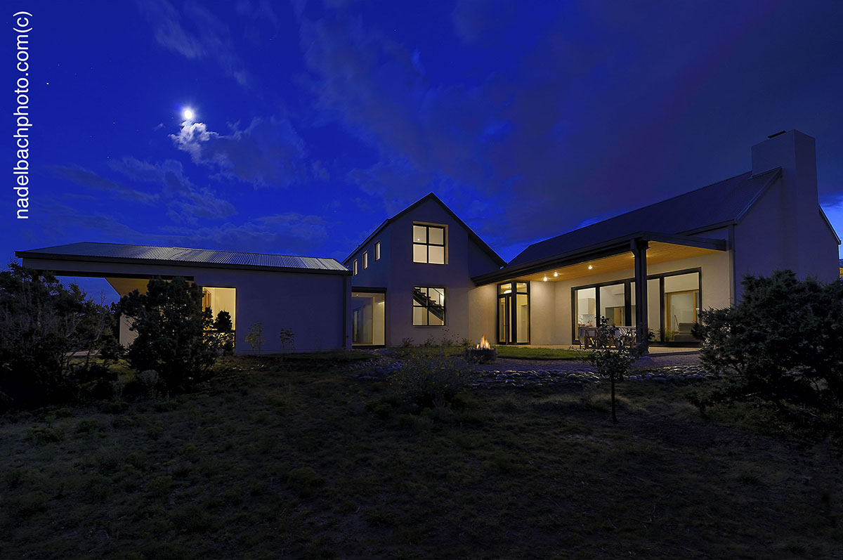 A Santa Fe-inspired white house with a blue sky.