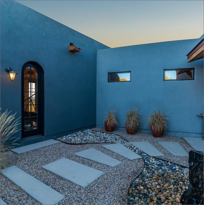 A home designer/architect/ will create a stunning blue exterior for your dream home, complemented by an elegant stone walkway.