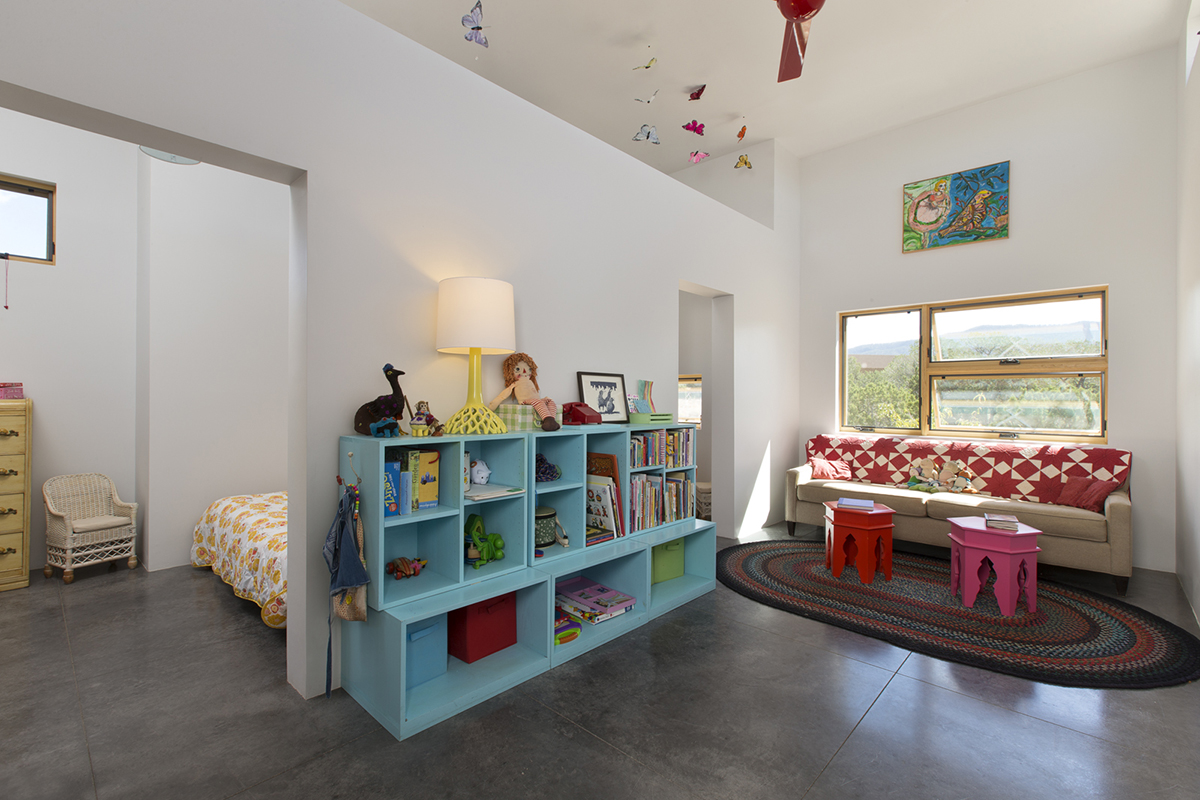 An architecturally designed child's room featuring a shelf and a table.