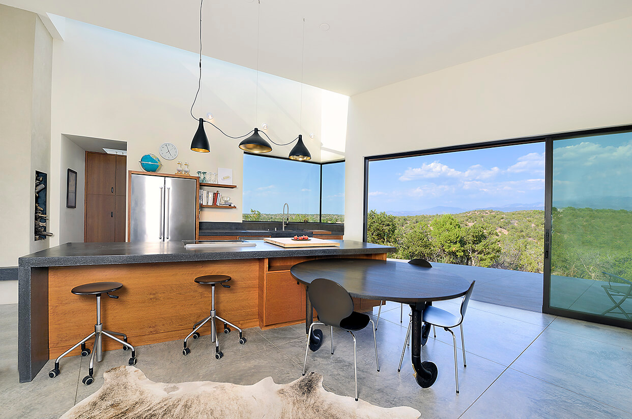 A modern kitchen with a cowhide rug, designed by a Santa Fe home designer.