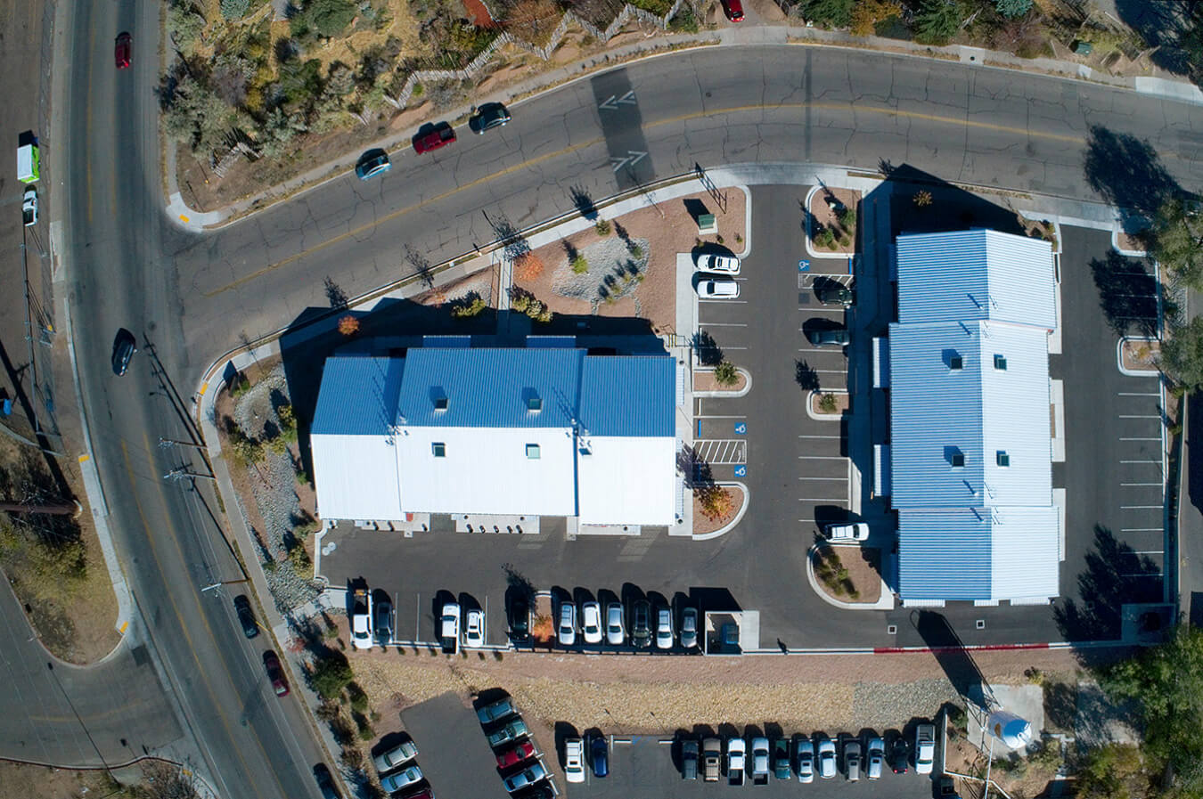 An aerial view of a Santa Fe building with a blue roof.