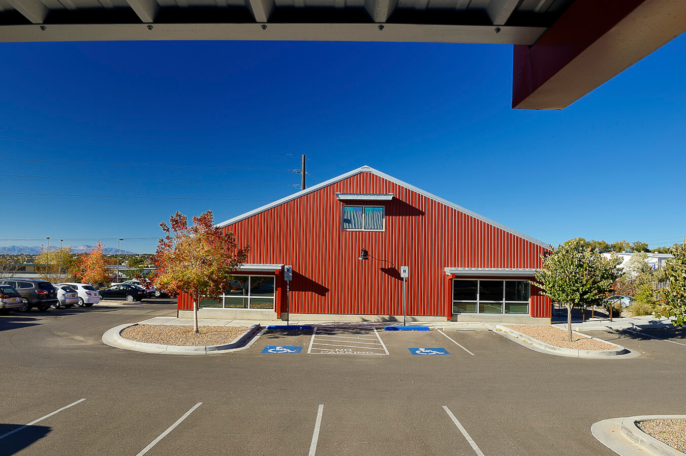 A Santa Fe parking lot with a red building.
