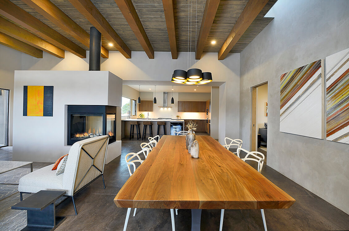 A home builder created a dining room with a wooden table and chairs.