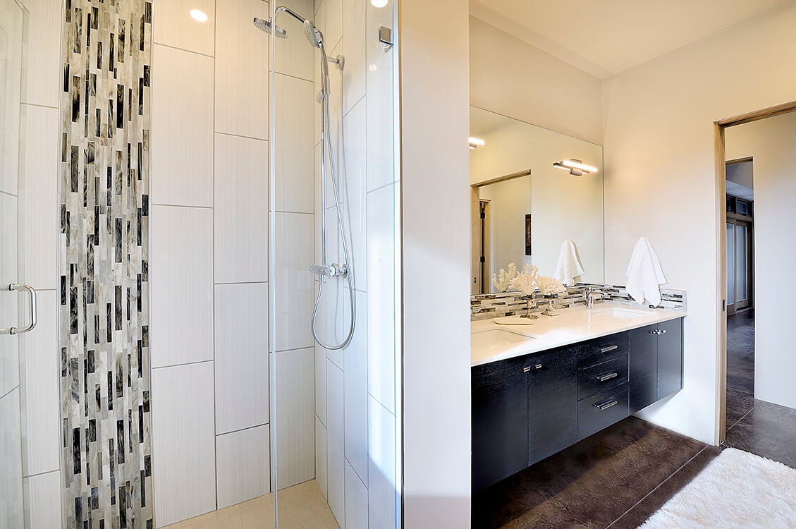A bathroom designed by a home designer with a glass shower stall.