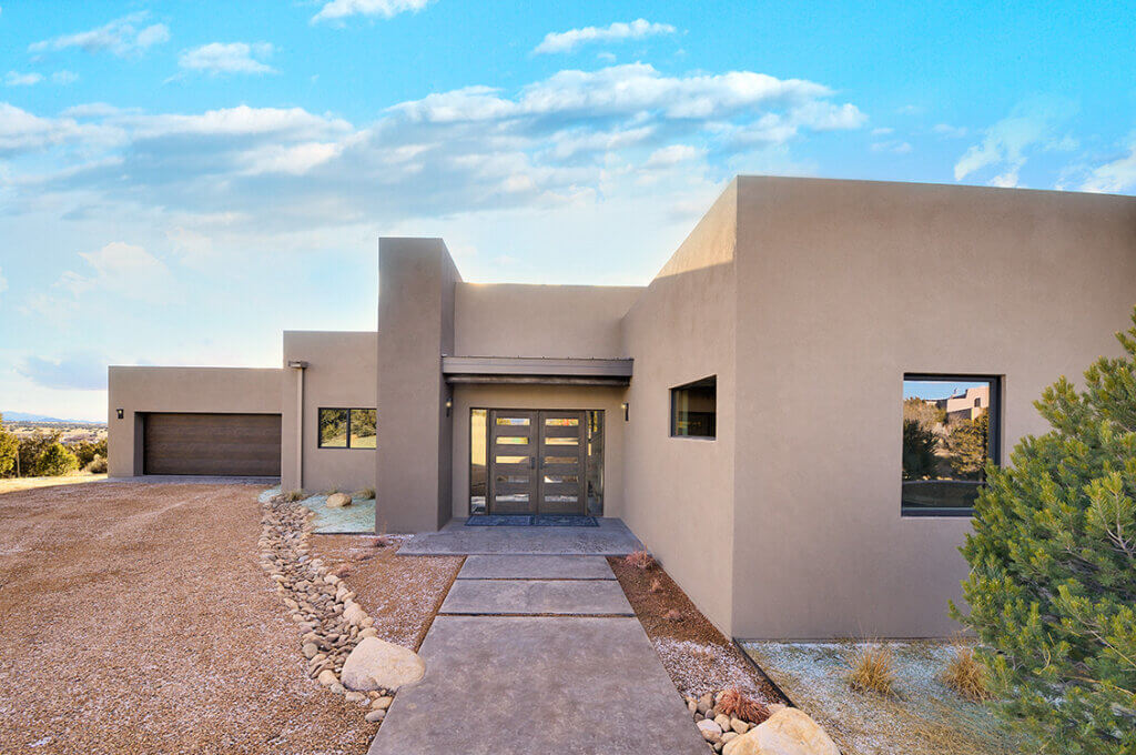 A modern home built by a home builder in Santa Fe, featuring a spacious driveway and a convenient garage.
