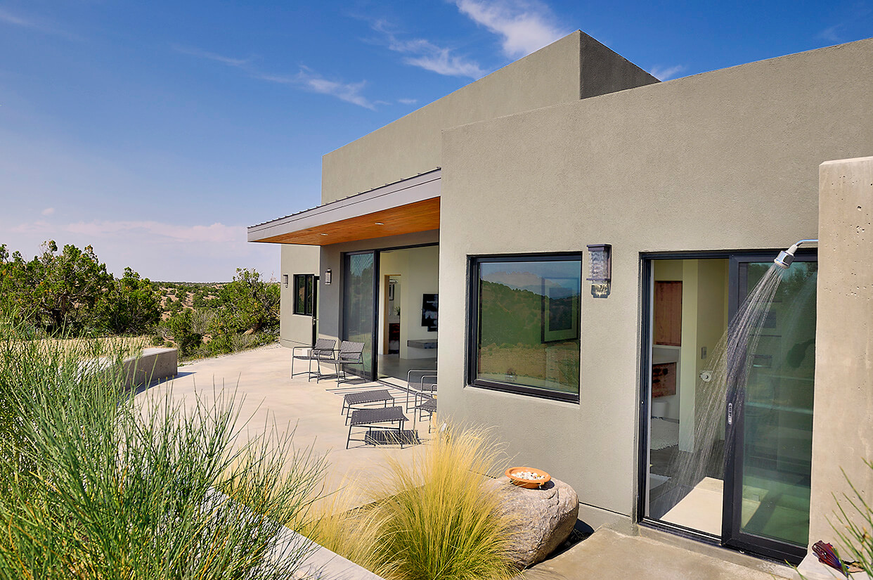 A Santa Fe home with a patio and a grassy area.