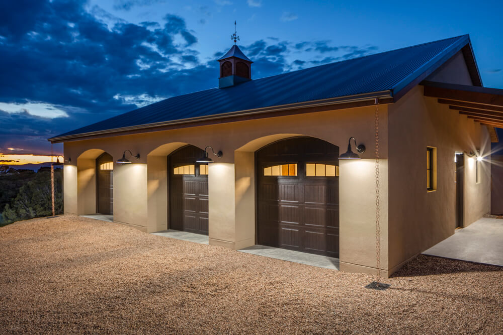 A home builder's dream - a garage with two garage doors at dusk.