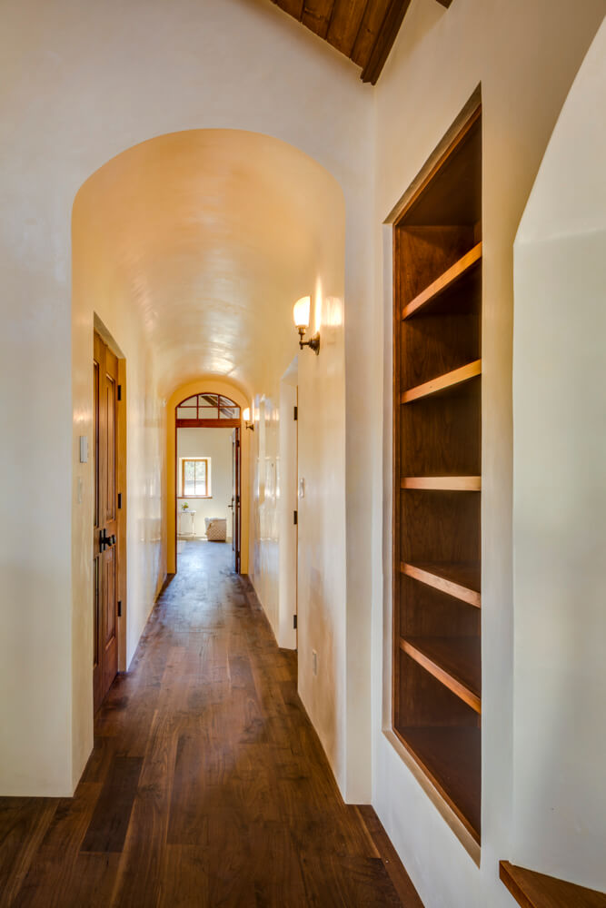 A hallway with bookshelves, designed by a home designer.