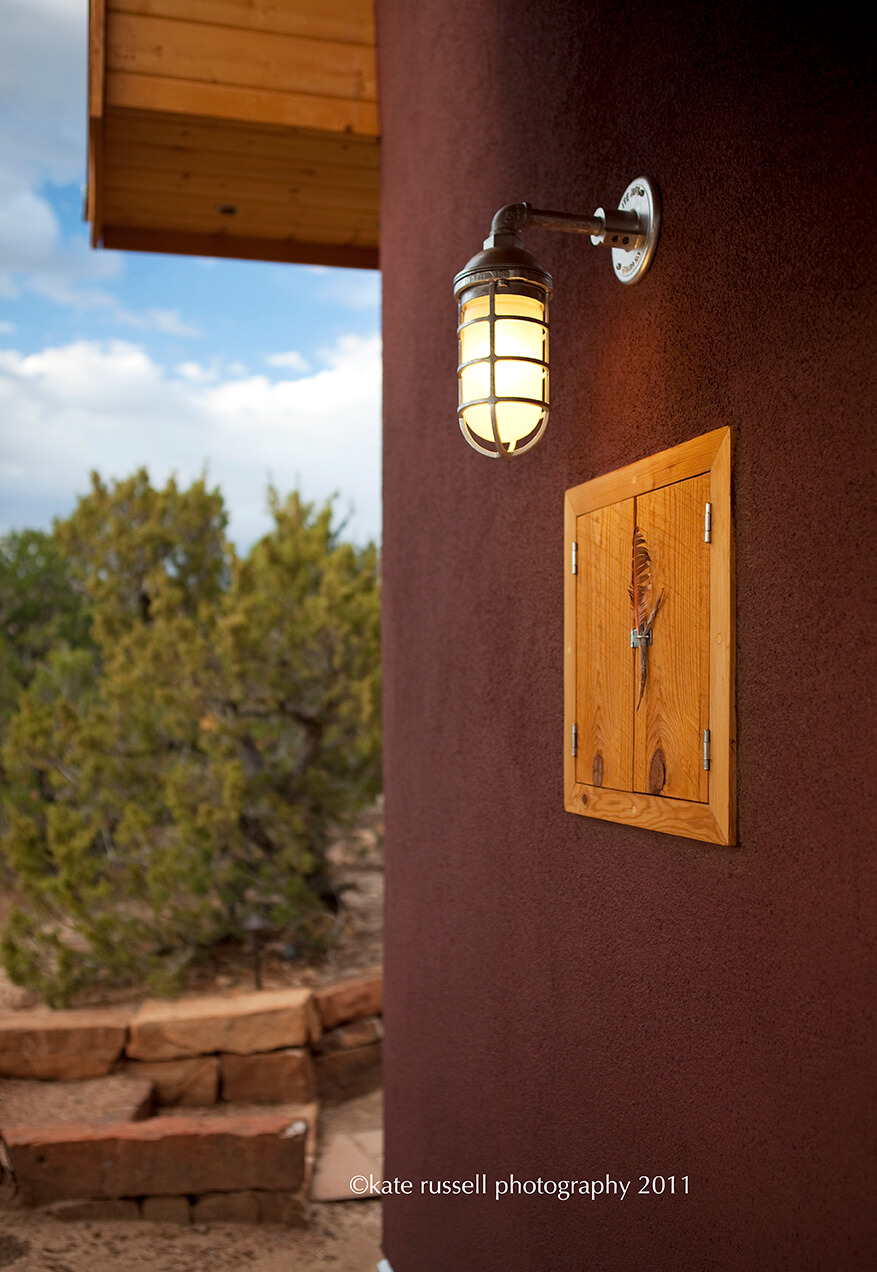 A Santa Fe-inspired light fixture on the side of a house.