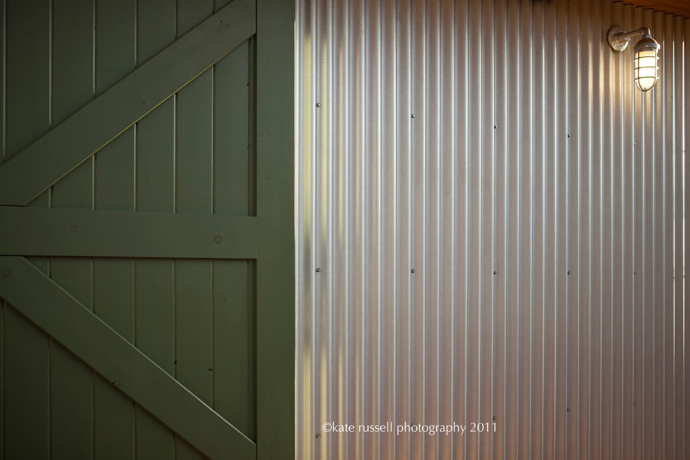 A barn door with a light on it designed by an architect.