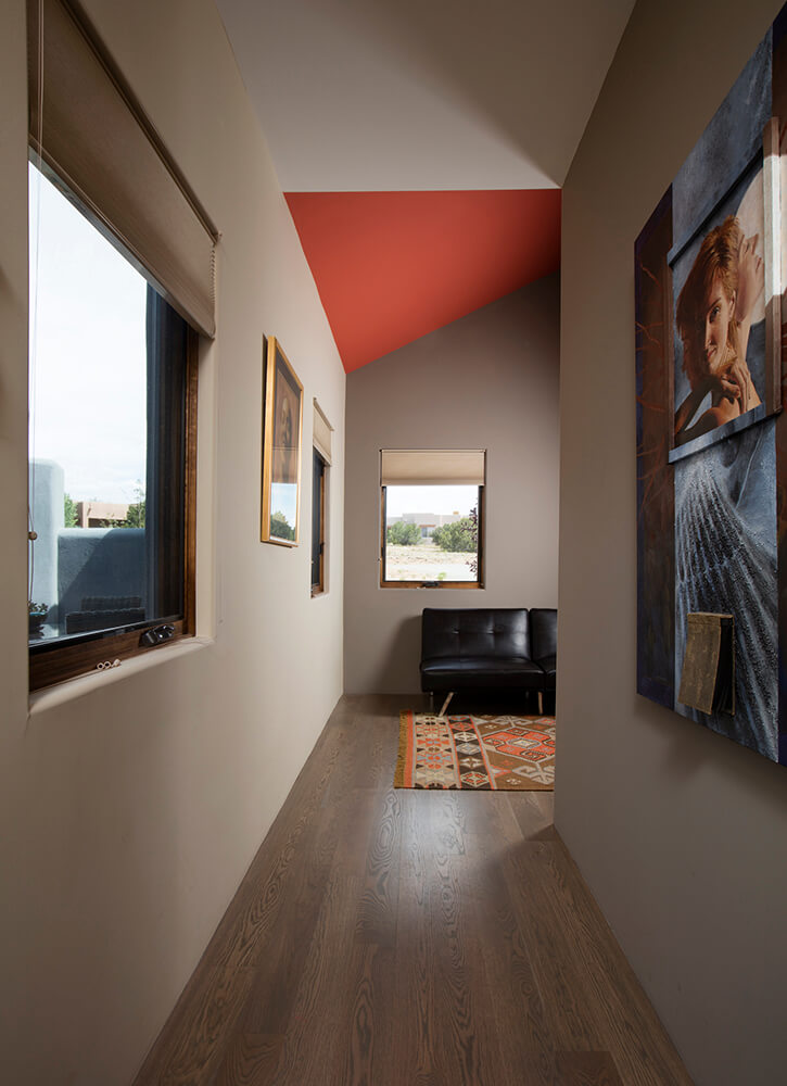 A hallway decorated with a painting on the wall, designed by a home designer.