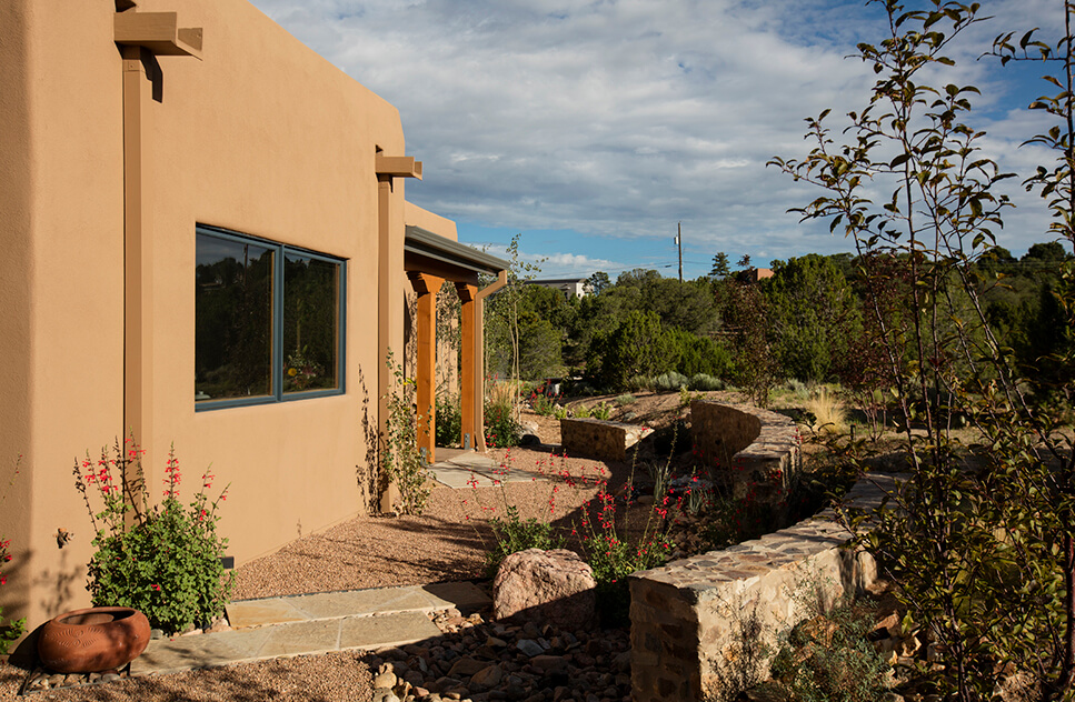 A Santa Fe-inspired building with a stone walkway.