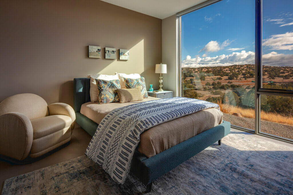 A beautifully designed bedroom with a stunning view of the mountains, created by an architect.