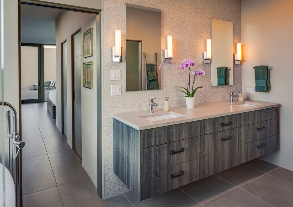 A bathroom with two sinks and a tub, expertly crafted by a skilled Santa Fe home builder.