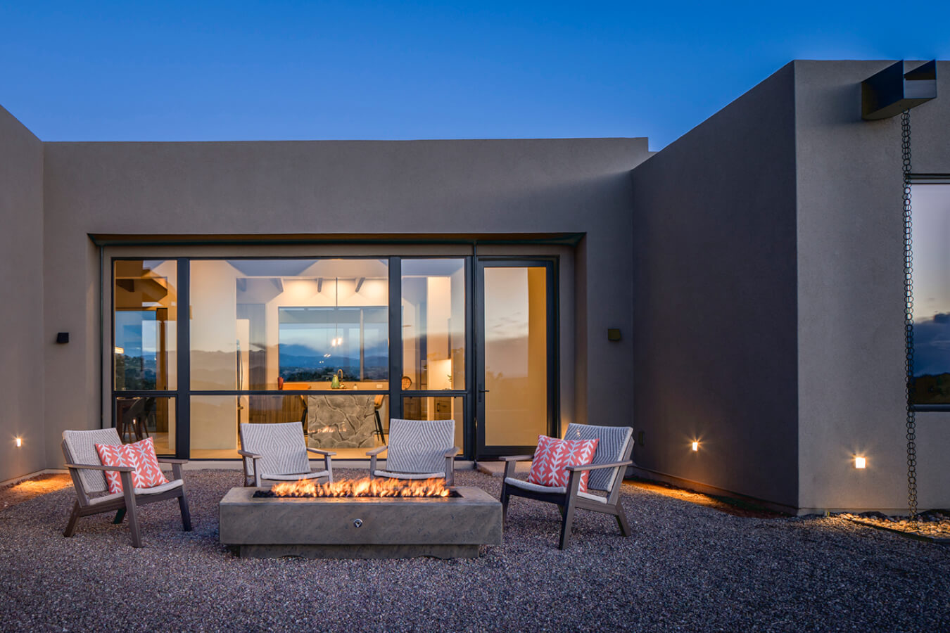 A modern home with a fire pit in the backyard, designed by a Santa Fe architect.
