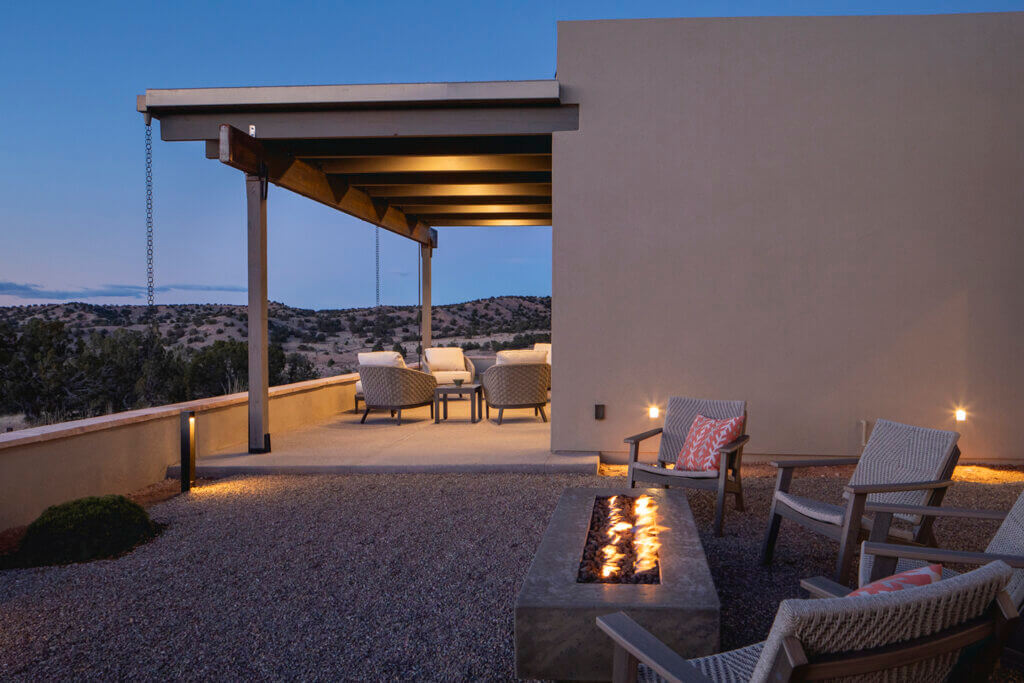 A Santa Fe-inspired patio with chairs and a fire pit.