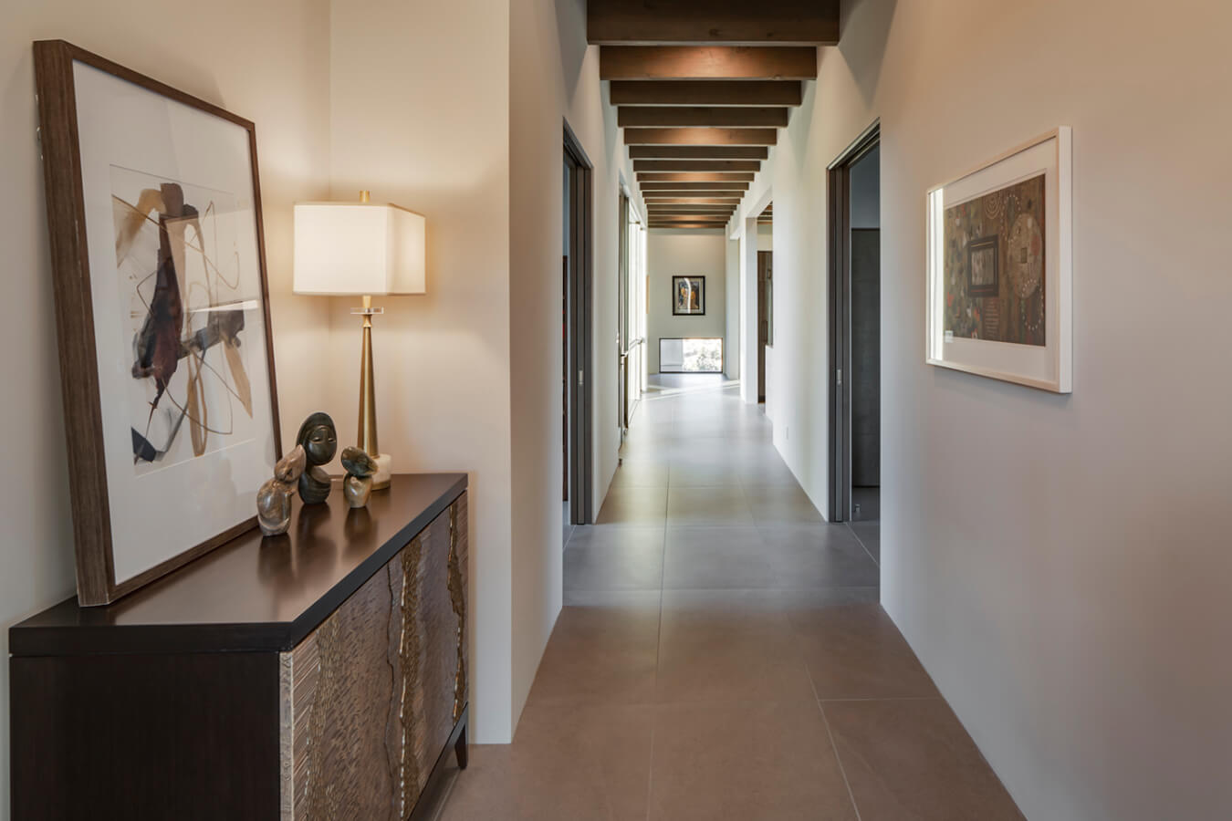 A Santa Fe-inspired hallway in a modern home with wooden flooring, designed by an architect and built by a home builder.