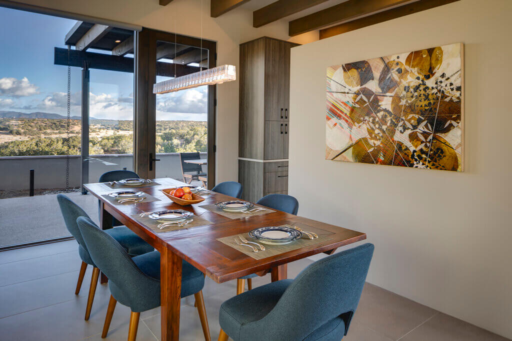 A dining room designed by an architect with a view of the mountains.